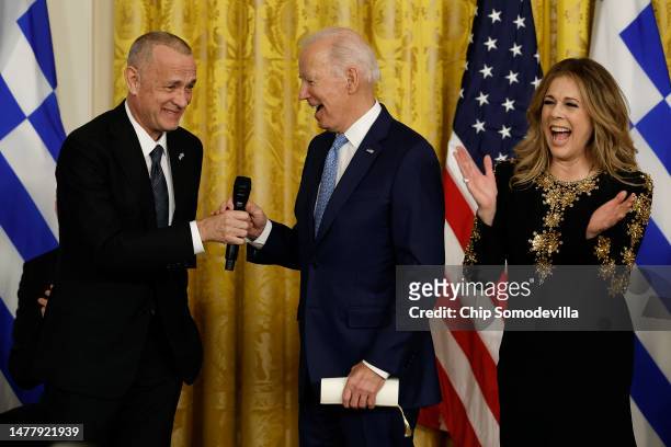 President Joe Biden joins actors Tom Hanks and Rita Wilson after Wilson sang four songs during a reception celebrating Greek Independence Day in the...