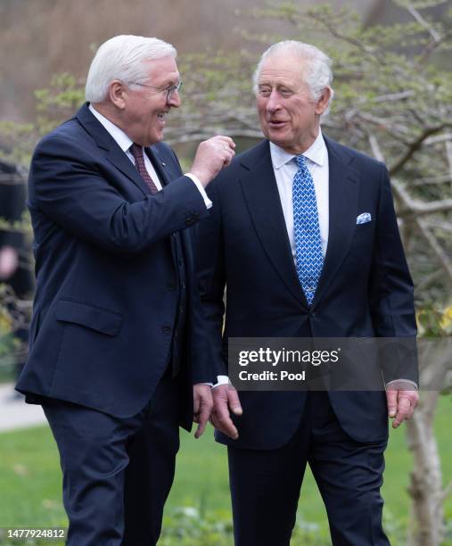 German President Frank-Walter Steinmeier and King Charles III walk together in the gardens on their way to plant a tree as part of the Queen’s Green...