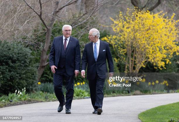 German President Frank-Walter Steinmeier and King Charles III walk together in the gardens on their way to plant a tree as part of the Queen’s Green...