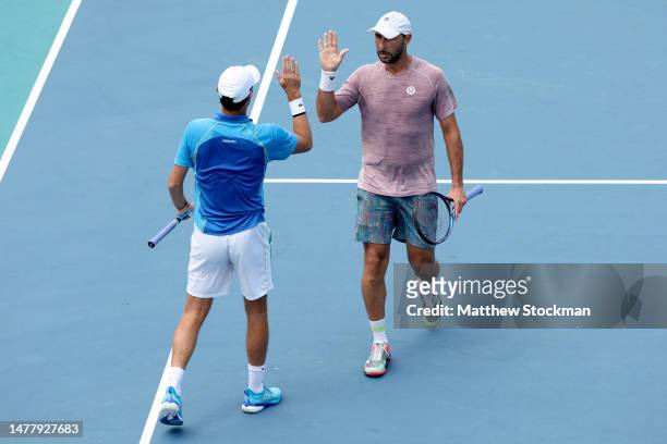 Edauard Roger-Vasselin of France and Santiago Gonzalez of Mexico celebrate a point against Wesley Koolhof of Netherlands and Neal Skupski of Great...