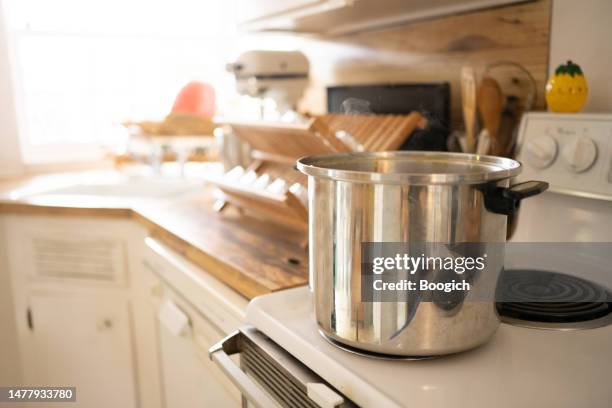 stainless steel pot boiling water on stovetop - stew pot stock pictures, royalty-free photos & images