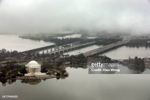 An aerial view of the Thomas Jefferson Memorial and the Tidal Basin are seen during high tide amid cherry blossoms in peak bloom on March 25, 2023 in...