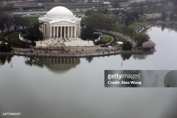 An aerial view of the Thomas Jefferson Memorial at the Tidal Basin is seen during high tide amid cherry blossoms in peak bloom on March 25, 2023 in...