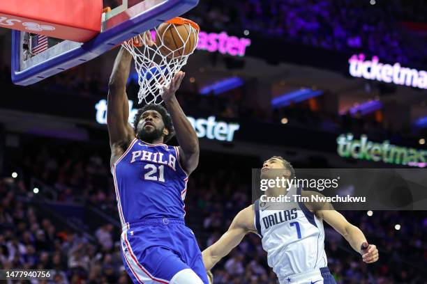 Joel Embiid of the Philadelphia 76ers dunks past Dwight Powell of the during the first quarter at Wells Fargo Center on March 29, 2023 in...