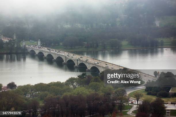 An aerial view of the Memorial Bridge is seen during high tide amid cherry blossoms in peak bloom on March 25, 2023 in Washington, DC. According to a...