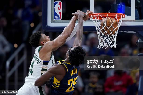 Giannis Antetokounmpo of the Milwaukee Bucks dunks the ball over Jalen Smith of the Indiana Pacers in the fourth quarter at Gainbridge Fieldhouse on...