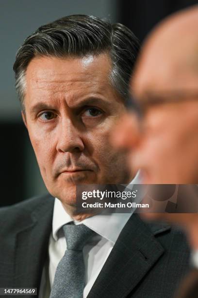 Australian Minister for Health and Aged Care Mark Butler looks on as Australian Chief Medical Officer, Professor Paul Kelly, addresses the media at...
