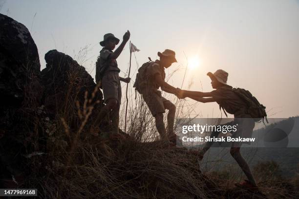 boy scout asian scout leader stands - indochina stock pictures, royalty-free photos & images