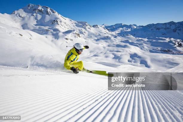 carving on groomed ski run - ski hill stock pictures, royalty-free photos & images