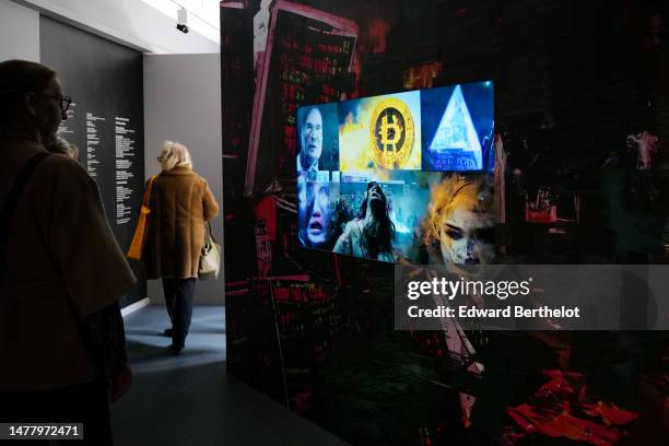 Visitor looks at a piece of art depicting a bitcoin, during the "Money In Art " : Press Preview at Monnaie de Paris on March 29, 2023 in Paris,...