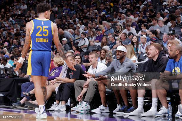 Lester Quiñones of the Golden State Warriors talks with Andre Iguodala of the Golden State Warriors during the game against the Sacramento Kings...