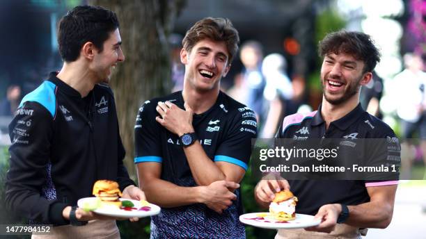 Esteban Ocon of France and Alpine F1, Jack Doohan of Australia and Alpine F1 and Pierre Gasly of France and Alpine F1 take part in a food challenge...