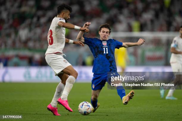 Brenden Aaronson of the United States makes a challenge against Ramin Rezaeian of IR Iran during a FIFA World Cup Qatar 2022 Group B match between...