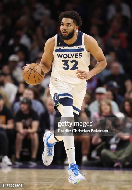 Karl-Anthony Towns of the Minnesota Timberwolves handles the ball during the first half of the NBA game against the Phoenix Suns at Footprint Center...