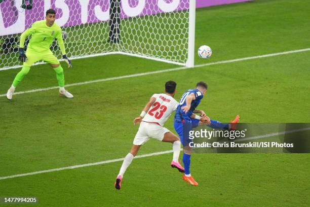 Christian Pulisic of the United States goes up for a header with Ramin Rezaeian ofIR Iran during a FIFA World Cup Qatar 2022 Group B match between IR...