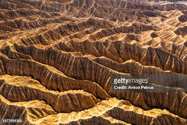 aerial view of desert landscape in kyrgyzstan at sunset. - mountain range aerial stock pictures, royalty-free photos & images
