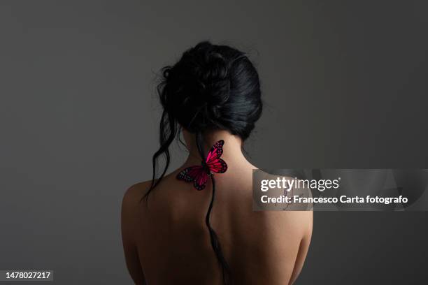 woman with butterfly on the back - tattoos of butterfly stock pictures, royalty-free photos & images