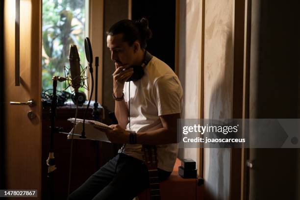 man writing and composing at the studio - writing music stock pictures, royalty-free photos & images