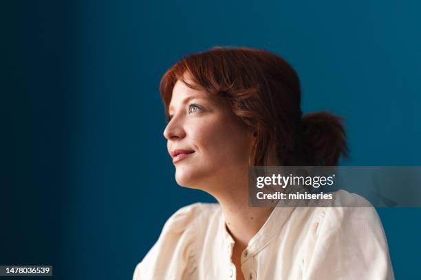 portrait of a happy young woman - blue backgrounds stock pictures, royalty-free photos & images