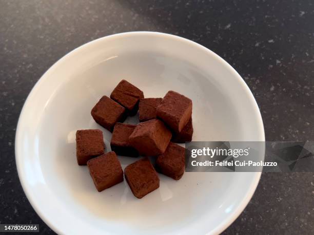 chocolate truffle in small cube shape with white plate - chocolate truffle stock pictures, royalty-free photos & images