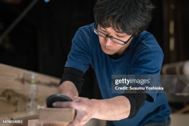young carpenters work by hand in the workshop to process lumber for home construction. - cryptomeria japonica stock pictures, royalty-free photos & images