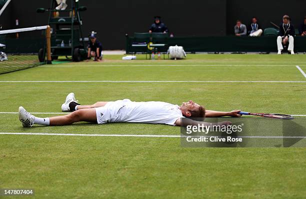 Florian Mayer of Germany celebrates match point during his Gentlemen's Singles fourth round match against Richard Gasquet of France on day eight of...