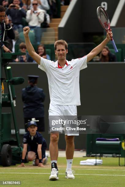 Florian Mayer of Germany celebrates winning his Gentlemen's Singles fourth round match against Richard Gasquet of France on day eight of the...