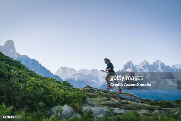 trail runner bounds along mountain trail - chamonix train stock pictures, royalty-free photos & images