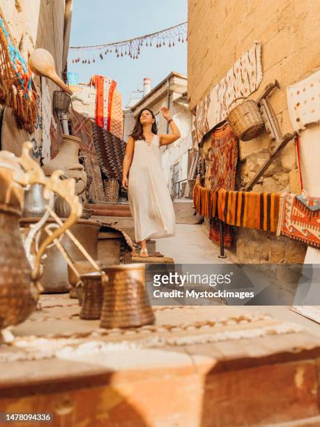 young woman wanders in the streets of göreme, turkey - feira árabe ao ar livre imagens e fotografias de stock