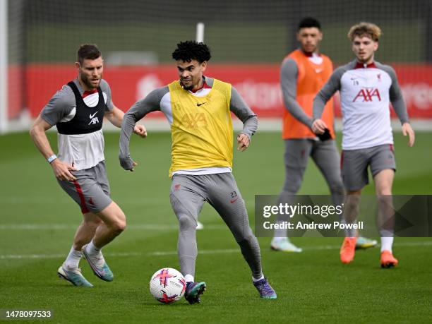 Luis Diaz and James Milner of Liverpool during a training session at AXA Training Centre on March 30, 2023 in Kirkby, England.