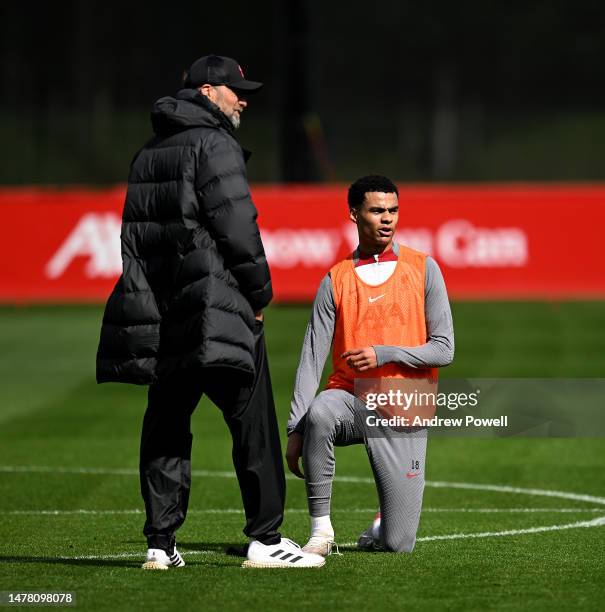 Jurgen Klopp manager of Liverpool talking with Cody Gakpo of Liverpool during a training session at AXA Training Centre on March 30, 2023 in Kirkby,...