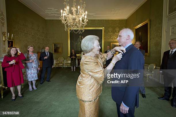Dutch queen Beatrix awards restoration and interior architect Krijn van den Ende with the Order of the House of Orange at the Huis ten Bosch Palace...