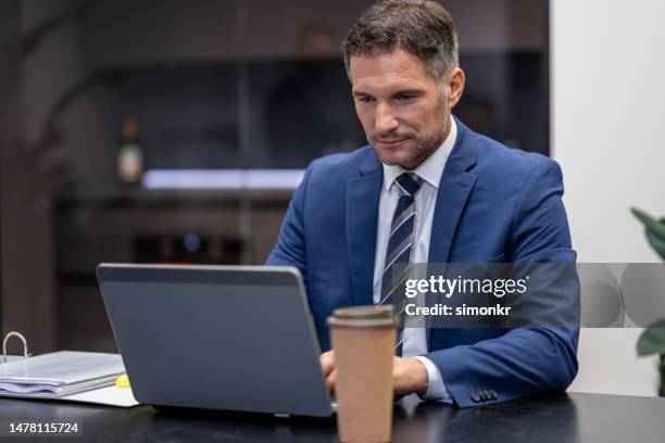 man using laptop - blue jacket stock pictures, royalty-free photos & images