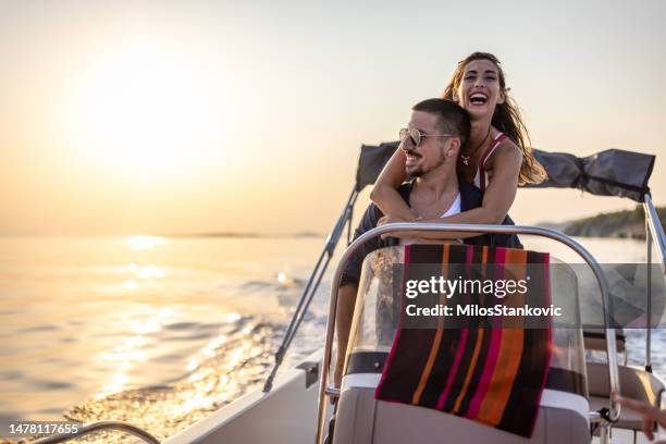 smile couple taking a boat ride on the sea - motor boat stock pictures, royalty-free photos & images