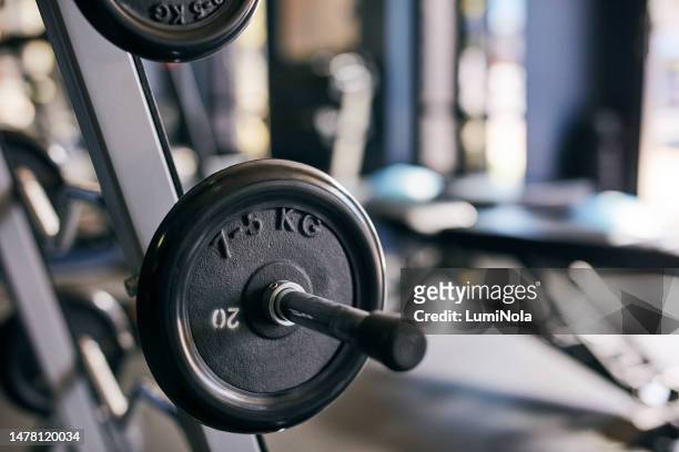 weights, gym and equipment for exercise, workout or training in a health centre for wellness and fitness. weightlifting, cardio and endurance machine made from steal and metal for sports lifestyle - cardio machine stock pictures, royalty-free photos & images