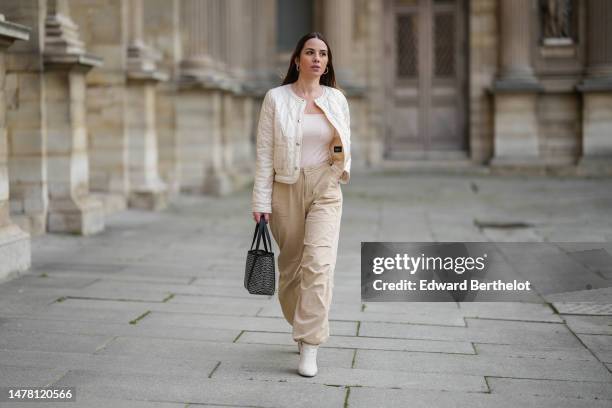 Maria Rosaria Rizzo wears a beige quilted checkered pattern / buttoned jacket from Emme by Marella, beige puffy large pants from Emme by Marella, a...