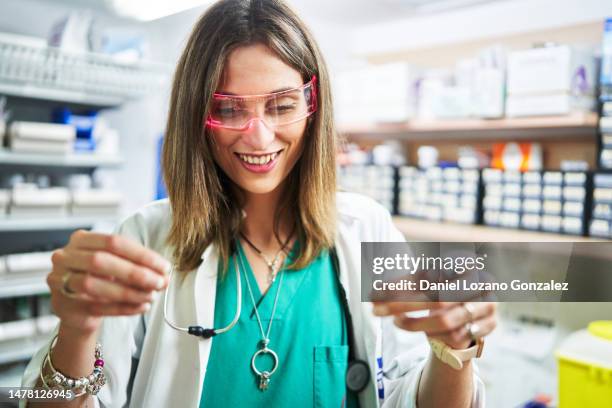 happy doctor using artificial intelligence goggles in a supply room - public service stock pictures, royalty-free photos & images