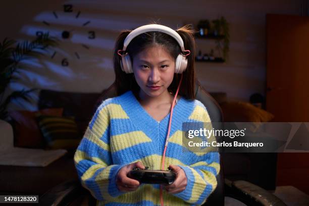 concentrated girl playing video games at home. - playstation stock pictures, royalty-free photos & images