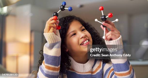 girl, science with happy child and molecular structure, learn chemistry or physics, student smile and education. notebook, homework and study at desk, ball and stick model, creative and scientific - school science project stock pictures, royalty-free photos & images