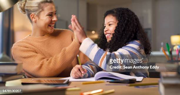 mother high five child for learning success, home education and teaching congratulations, support and well done. happy woman, biracial girl kid and hands together for writing goals or development - mother congratulating stock pictures, royalty-free photos & images