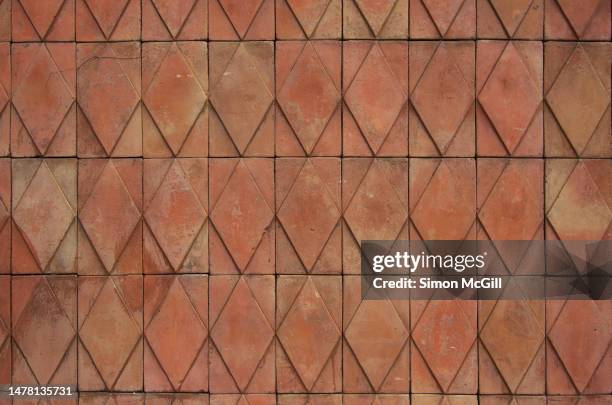 terracotta color clay wall tiles with a diamond-shaped relief pattern - terracotta fotografías e imágenes de stock