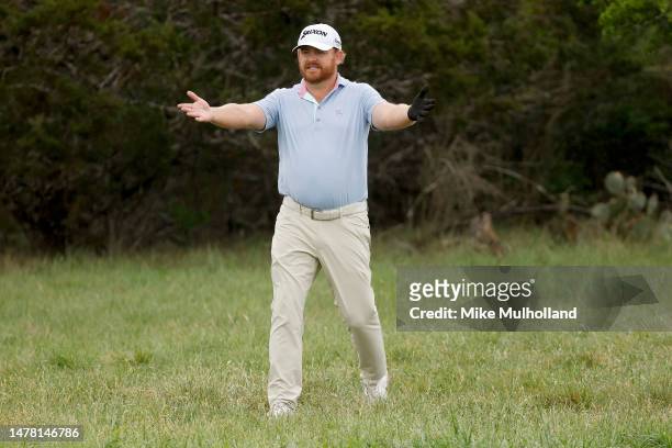 Holmes of the United States reacts to his shot on the second hole during the first round of the Valero Texas Open at TPC San Antonio on March 30,...
