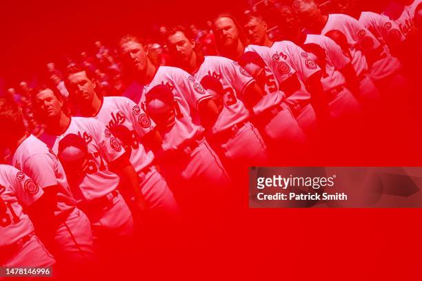 The Washington Nationals stand for the U.S. National Anthem before playing against the Atlanta Braves on Opening Day at Nationals Park on March 30,...