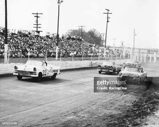 April 29, 1956: Action during the NASCAR Convertible race at Greensboro Fairgrounds has the No. 22 Ford of Glen Wood leading the Buick of Bill...