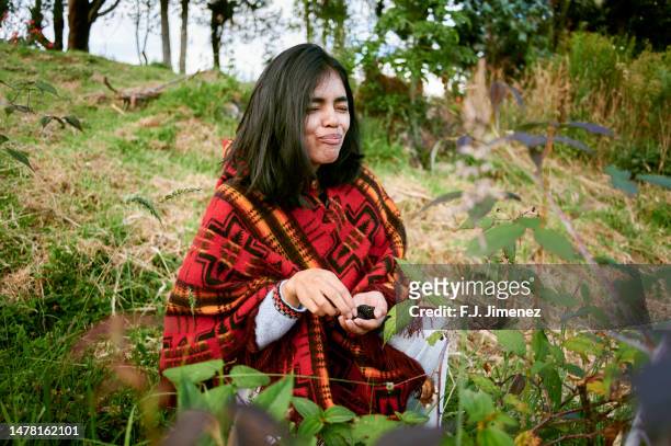 woman eating wild raspberries in the forest - traditional colombian clothing stock pictures, royalty-free photos & images