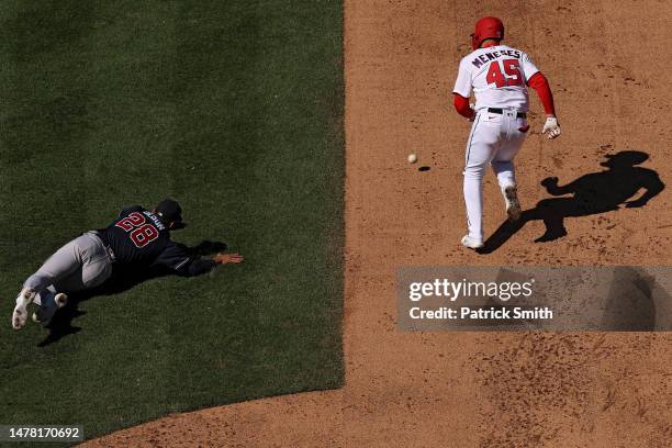 Joey Meneses of the Washington Nationals advances to second base after Matt Olson of the Atlanta Braves cannot make a play on a hit during the fifth...