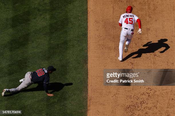 Joey Meneses of the Washington Nationals advances to second base after Matt Olson of the Atlanta Braves cannot make a play on a hit during the fifth...