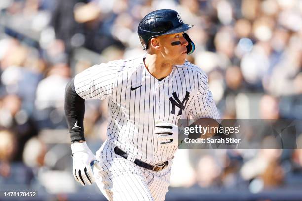 Aaron Judge of the New York Yankees hits an RBI single during the seventh inning against the San Francisco Giants on Opening Day at Yankee Stadium on...