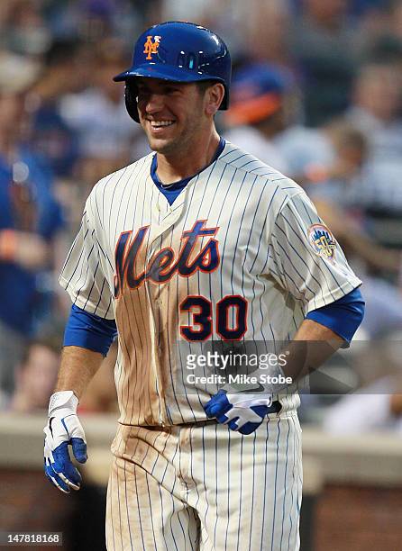 Josh Thole of the New York Mets celebrates after scoring on a Ruben Tejada RBI single in the fourth inning against the Philadelphia Phillies at Citi...