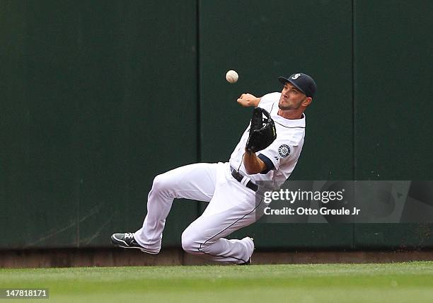 Left fielder Casper Wells of the Seattle Mariners catches a deep fly ball by Adam Jones of the Baltimore Orioles at Safeco Field on July 3, 2012 in...